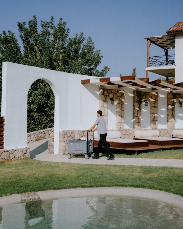 Professional hospitality support staff pushing a service trolley at a luxury resort, representing Smart Agnes’s premium housekeeping and facilities manpower for Qatar’s hotel sector.